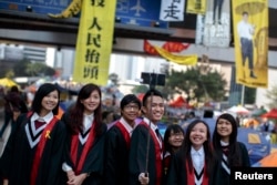 FILE - Graduate students have their picture taken at an Occupy Central protest site outside the government headquarters at Admiralty in Hong Kong, Dec. 9, 2014.