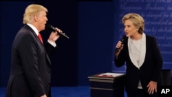FILE - In this Sunday, Oct. 9, 2016, file photo, Republican presidential nominee Donald Trump and Democratic presidential nominee Hillary Clinton speak during the second presidential debate at Washington University in St. Louis.