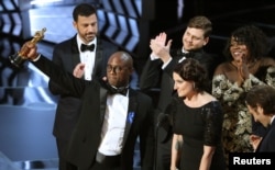 Writer and Director Barry Jenkins of "Moonlight" holds up the Best Picture Oscar.