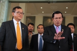 រូបឯកសារ៖ លោកនាយករដ្ឋមន្រ្តីហ៊ុន សែន និយាយ​ទៅកាន់​សារព័ត៌មាន ដោយ​មាន​លោក សម រង្សី ប្រធាន​គណបក្ស​សង្គ្រោះ​ជាតិ​ឈរ​អម​នៅ​មុខ​រដ្ឋសភា​ជាតិ​ បន្ទាប់ពី​ការបោះឆ្នោត​ផ្តល់​សេចក្តី​ទុក​ចិត្ត​ដល់​គណៈកម្មាធិការ​ជាតិ​រៀបចំ​ការបោះឆ្នោត នៅ​វិមាន​រដ្ឋសភា​រាជធានី​ភ្នំពេញ ថ្ងៃទី៩ ខែមេសា ឆ្នាំ២០១៥។ (វីអូអេ)