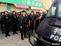 Policemen patrol at Wukan village in China's Guangdong province, June 20, 2016.