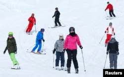 Skiers and snowboarders share the slopes.