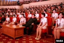 North Korean leader Kim Jong Un (3rd R) and wife Ri Sol Ju (4th L) enjoy an art performance given by the Chongbong Band to mark the 70th anniversary of the founding of the Workers' Party of Korea (WPK)