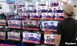 A man watches TV news report about North Korea's nuclear test at an electronic shop in Seoul