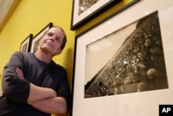 Dennis McNally stands by a photograph of the "Human Be-In" at the exhibit "On the Road to the Summer of Love" in the California Historical Society in San Francisco.