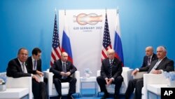 President Donald Trump meets with Russian President Vladimir Putin at the G-20 Summit in Hamburg, July 7, 2017. Russian Foreign Minister Sergey Lavrov is at left, Secretary of State Rex Tillerson is at right.