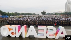 Thousands of police and soldiers stand at attention during a send off ceremony and deployment to provide security for next week's ASEAN Summit and other related summits which the country is hosting in Manila, Philippines Sunday, Nov. 5, 2017. 
