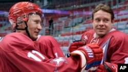 Myanmar Buddhist monks hold fans as sunshades during a protest march by students and Buddhist monks in Letpadan, some 130 kilometers (80 miles) north of Myanmar's main city of Yangon. Students have rallied for months over a controversial education bill that they say is undemocratic.