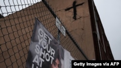 A sign asks people to get the COVID vaccine in a Brooklyn neighborhood which is witnessing a rise in COVID-19 cases on July 13, 2021, in New York City. 