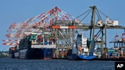 FILE - Container ships are docked at the Port of New York and New Jersey in Elizabeth, New Jersey, May 20, 2021.