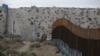 FILE - A border fence separates the towns of Anapra, Mexico, and Sunland Park, New Mexico, Nov. 10, 2016. 