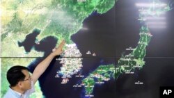 FILE - In this Sept. 3, 2017, file photo, Earthquake and Volcano of the Korea Monitoring Division Director Ryoo Yong-gyu speaks to the media about North Korea's artificial earthquake with a map of the Korean peninsular in Seoul, South Korea. (AP Photo/Lee Jin-man, File)