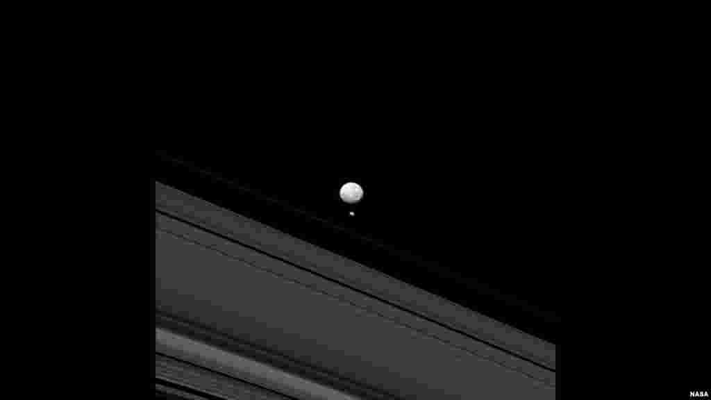 The Saturn moons Mimas and Pandora appear together in this image taken by NASA's Cassini spacecraft. Pandora's small size means that it lacks sufficient gravity to pull itself into a round shape like its larger sibling, Mimas. (NASA/JPL-Caltech/Space Science Institute)
