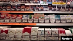 FILE - Cigarette packs are seen on shelves in a tobacco shop in Cagnes-sur-Mer, France, Sept. 8, 2015. (REUTERS/Eric Gaillard)