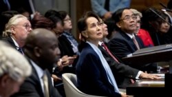 (FILES) In this file photo taken on December 11, 2019 Myanmar's State Counsellor Aung San Suu Kyi (C) stands before the UN's International Court of Justice next to Abubacarr Tambadou (2L), minister of justice of the Gambia, in the Peace Palace of…