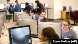 FILE - Students work on computers at the James Branch Cabell library on the campus of Virginia Commonwealth University in Richmond, Virginia, April 28, 2016. (AP Photo/Steve Helber)