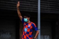 បាតុករ​ប្រឆាំង​រដ្ឋាភិបាល​ថៃ​ម្នាក់​លើក​ដៃ​ធ្វើ​សញ្ញា​ម្រាម​៣ក្នុង​អំឡុង​បាតុកម្ម​មួយនៅ​ទី​ក្រុង​បាងកក​ កាល​ពី​ថ្ងៃ​ទី២៥ ខែ​កក្កដា ឆ្នាំ​២០២១។ (វីអូអេ/Tommy Walker)