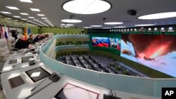 Russian President Vladimir Putin, fifth left, and other top officials oversee the test launch of the Avangard hypersonic missile from the Defense Ministry's control room in Moscow, Dec. 26, 2018. 