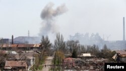 Smoke rises above a plant of Azovstal Iron and Steel Works company in Mariupol