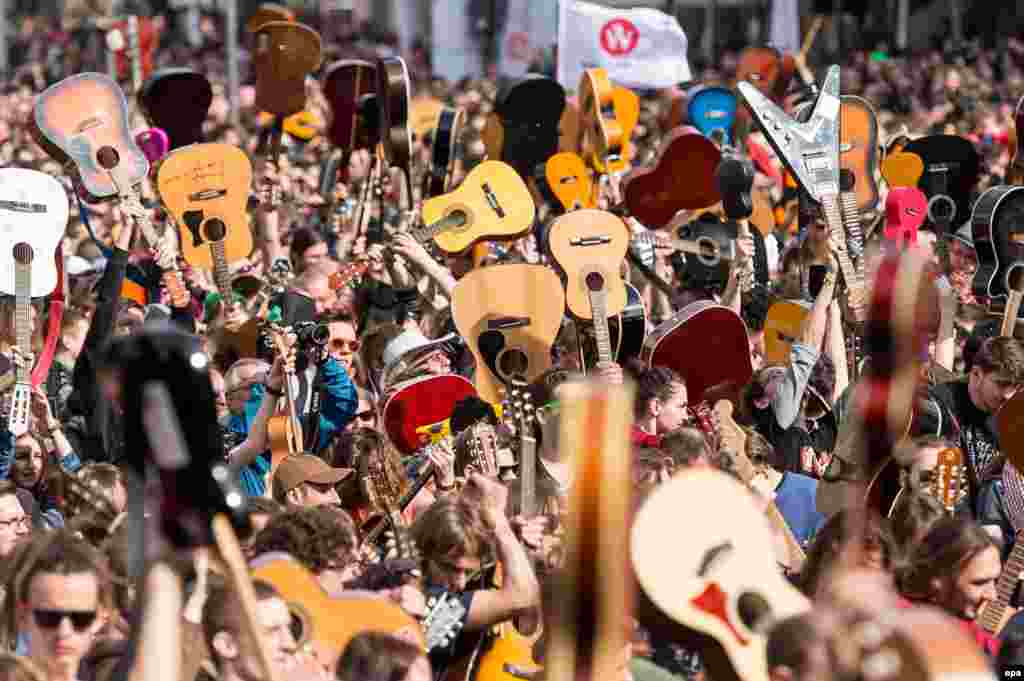 A mass gathering of guitarists attempt to beat the Guinness record for ensemble guitar playing in Wroclaw, Poland.&nbsp;According to media reports 7,356 musicians gathered in Wroclaw Market Square to play Jimi Hendrix's hit 'Hey Joe'.