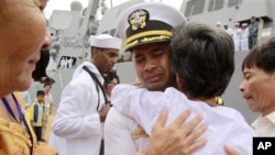 U.S. navy officer Michael "Vannak Khem" Misiewicz becomes emotional in December 2010 as he embraces his aunt Samrith Sokha, 72, at Cambodian coastal international sea port of Sihanoukville, file photo. 