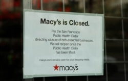 Sign reading closure of Macy's is seen on storefront window, March 30, 2020, in San Francisco.