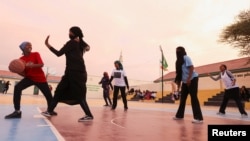 Sahra Omer, 17, member of the Hargeisa Basketball Girls team tussles to shoot a ball during their weekly training session in Hargeisa, Somaliland, May 20, 2024. (REUTERS/Tiksa Negeri)