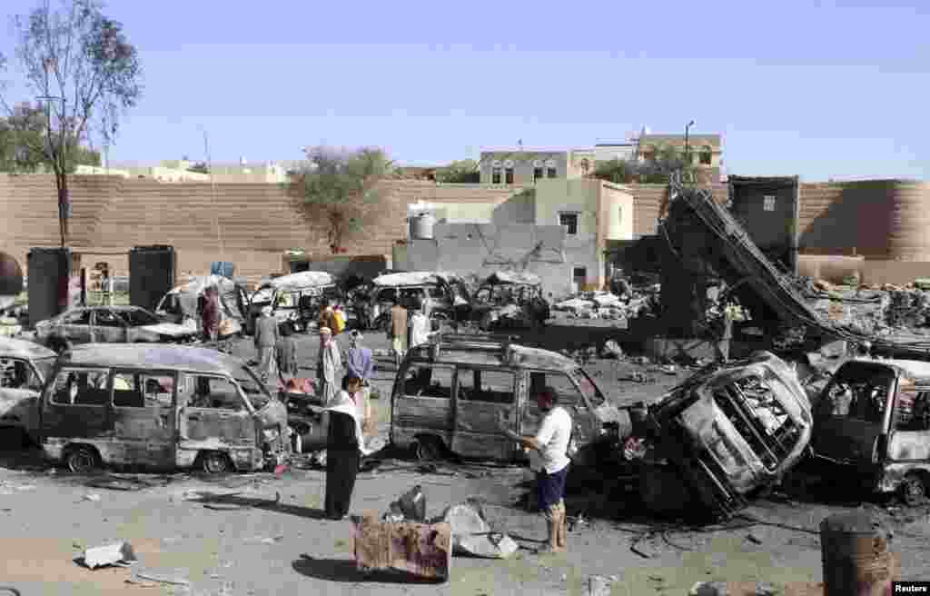 Destroyed vehicles are seen at a gas station after it was hit by an airstrike in Yemen's northwestern city of Saada, April 16, 2015.