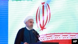 In this photo released by the official website of the office of the Iranian Presidency, President Hassan Rouhani speaks in a ceremony in Tehran, Iran, Aug. 27, 2019.