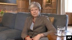 In this image taken from video released by Downing Street, April 7, 2019, showing Britain's Prime Minister Theresa May defending her position on Brexit, and her decision to hold cross-party talks with opposition Labour Party, in a video message filmed at 