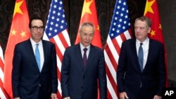 FILE - Chinese Vice Premier Liu He poses with U.S. Trade Representative Robert Lighthizer, right, and Treasury Secretary Steven Mnuchin, for photos before holding talks at the Xijiao Conference Center in Shanghai, July 31, 2019. 
