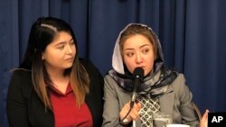 Mihrigul Tursun, right, speaks at a event at the National Press Club in Washington, Monday, Nov. 26, 2018. 