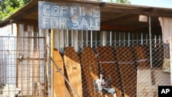 A worker at a coffin manufacturing company waits for clients in Harare, as Zimbabwe begins a 30-day lockdown in a bid to rein in the spike in COVID -19 infections threatening to overwhelm health services.