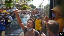 FILE - Anti-coup protesters shout slogans during a demonstration, May 6, 2021, in Yangon, Myanmar.