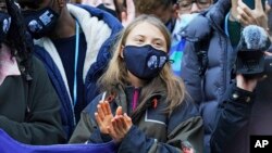 Swedish climate activist Greta Thunberg, centre, attends a 'Fridays For Future' climate protest on the fringes of the COP26 U.N. Climate Summit, in Glasgow, Scotland, Nov. 1, 2021. 