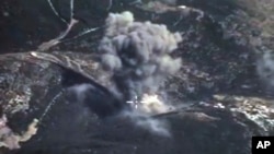 In this photo made from the footage taken from Russian Defense Ministry official web site on Oct. 4, 2015, an aerial view of a bomb explosion in Syria. 
