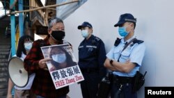 Pro-democracy supporters protest for the release of 12 Hong Kong activists arrested as they reportedly sailed to Taiwan and for citizen journalist Zhang Zhan, outside China's Liaison Office, in Hong Kong, China December 28, 2020. 