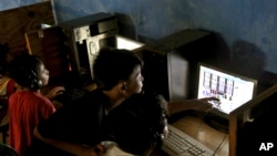 FILE - Indonesian youths browse their social media accounts at an Internet cafe in Jakarta, Indonesia.