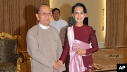 In this image provided by the Myanmar Ministry of Information, Myanmar President Thein Sein, left, shakes hands with opposition leader Aung San Suu Kyi during their meeting at the presidential in Naypyitaw, Myanmar, Dec. 2, 2015.