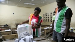 Election officials start to count ballots during the presidential election in Abidjan, Ivory Coast, Oct. 31, 2020.