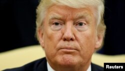 FILE - U.S. President Donald Trump concludes remarks to reporters during his meeting with Ukraine's President Petro Poroshenko in the Oval Office at the White House in Washington, June 20, 2017. 