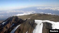 FILE - The peak of Mt. Kilimanjaro is seen from an aircraft in northeastern Tanzania, Oct. 31, 2005.