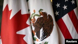 FILE - Flags are pictured during the fifth round of NAFTA talks involving the United States, Mexico and Canada, in Mexico City, Mexico, November 19, 2017.