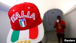 FILE - An adolescent migrant poses for a picture at an immigration center in Caltagirone, Italy, April 20, 2016.