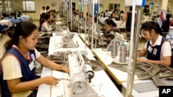 FILE PHOTO - Cambodian garment workers sew clothes in a factory in Phnom Penh, Cambodia, Aug. 4, 2007. (AP Photo/Heng Sinith)