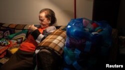Ioanna Matsouka, 93, knits scarves in her house in Athens, Greece, March 6, 2024. (REUTERS/Karolina Tagaris)