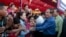 Prime Minister Hun Sen greets garment workers during a visit to a factory outside of Phnom Penh, Cambodia, Wednesday, Aug. 30, 2017. Hun Sen embarked on a country-wide trip to visit the nation's factory workers to hear their hopes and concerns in person. (AP Photo/Heng Sinith)