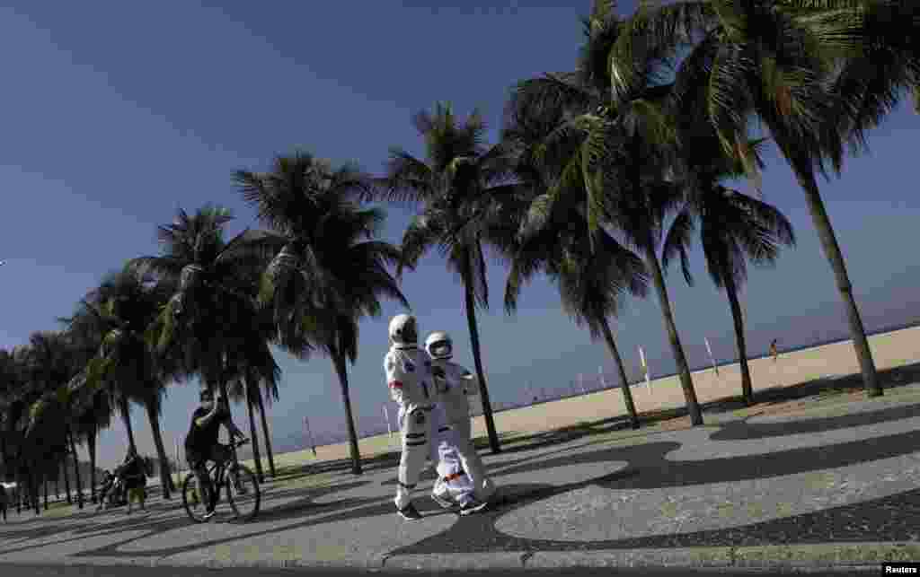 Tercio Galdino, 66, and his wife Aliceia, 65, wearing their protective 'space suits', walk on the sidewalk of Copacabana Beach amid the outbreak of the COVID-19 in Rio de Janeiro, Brazil, July 11, 2020.