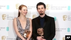 Actress Emma Stone with her BAFTA award for Best Actress and director Damien Chazelle with his BAFTA award for Best Director both for the film "La La Land' pose backstage at the British Academy Film Awards in London, Sunday, Feb. 12, 2017. 