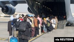 FILE - Evacuees assemble before boarding a C-17 Globemaster III during an evacuation at Hamid Karzai International Airport, Aug. 18, 2021. (U.S. Marine Corps/Lance Cpl. Nicholas Guevara/Handout via Reuters)